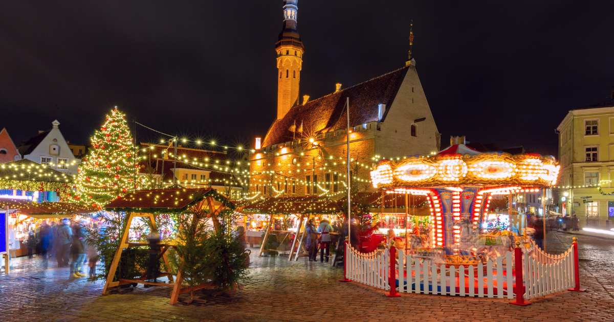 A festive small town dressed in Christmas lights at dusk.