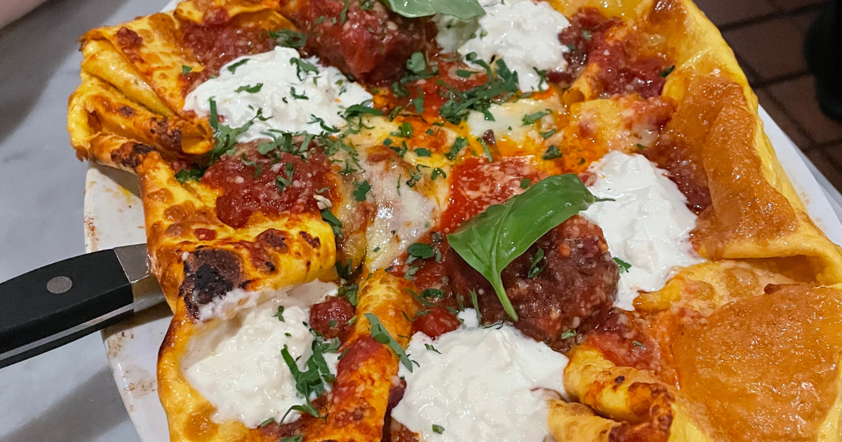 A large serving of lasagna with tomato sauce, basil, and melted cheese at Cafe Fiorello.