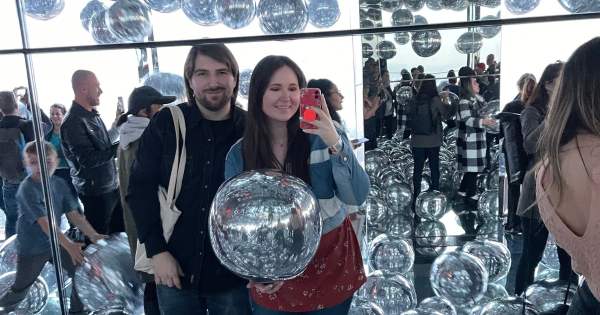 Visitors reflected among mirrored walls and silver spheres at Summit One Vanderbilt.